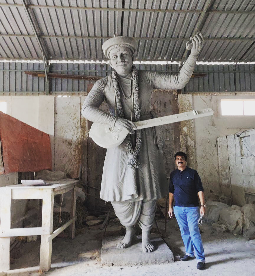 Master sculptor finishing a bronze bust in the studio